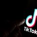 Tiktok,App,Logo,On,Screen,And,A,Finger,Pointing,At
